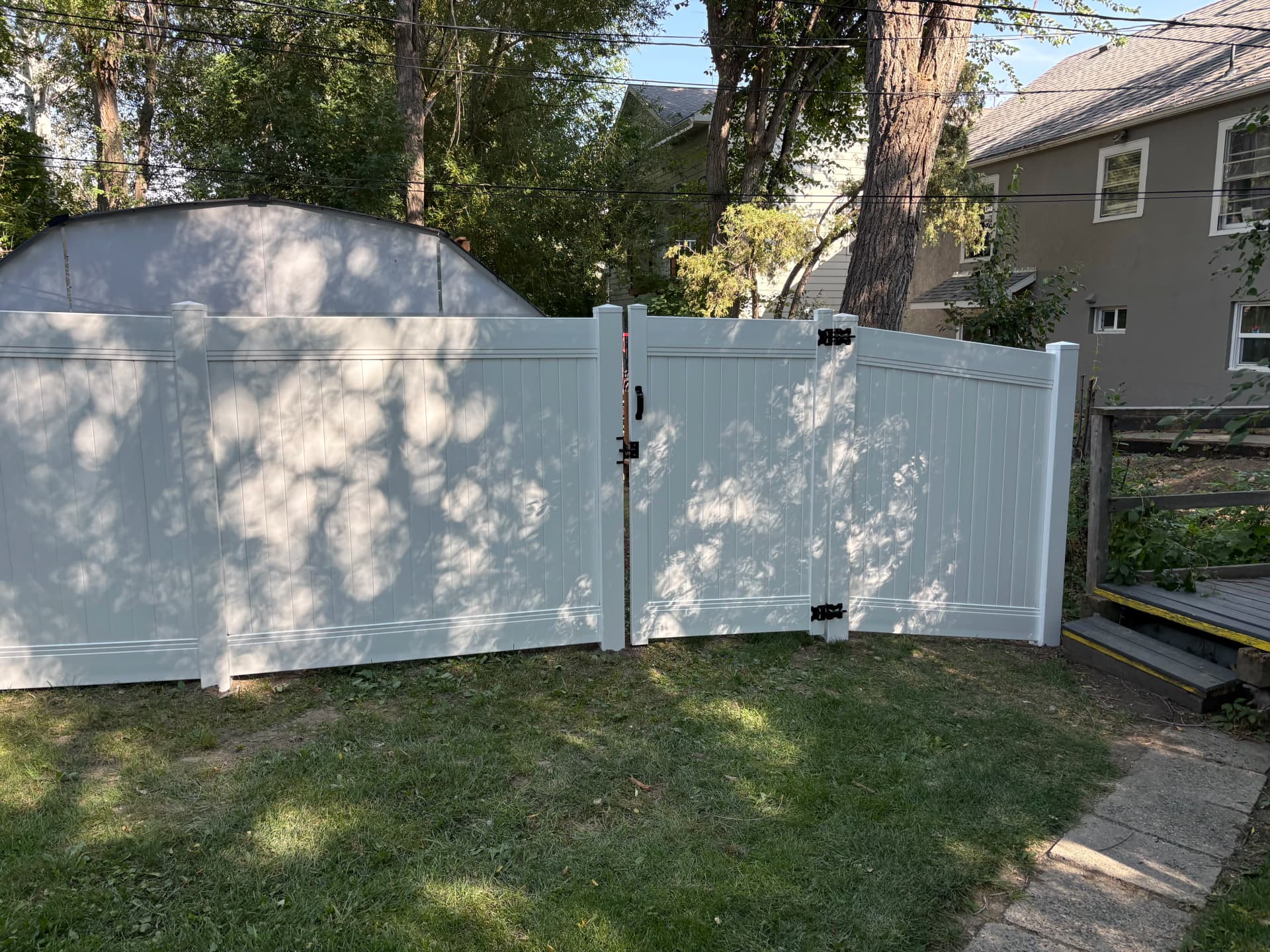 Vinyl Privacy Fence and Gate Installation for a Family Backyard image