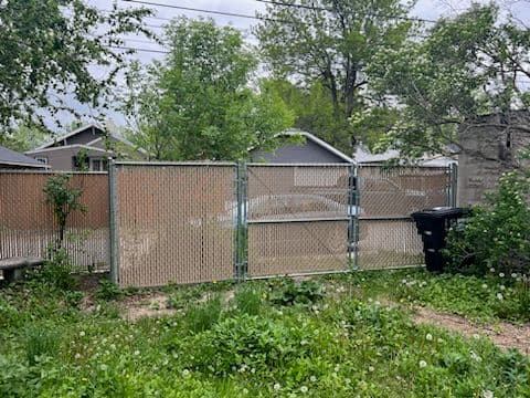 Secure Chain-Link Fence with Tan Privacy Slats